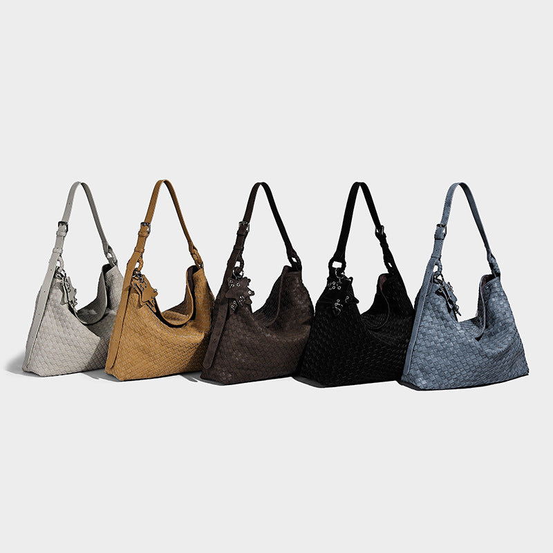 Large soft woven hobo shoulder bag with matte textured finish, adjustable strap, and star charm hardware, detail view 2