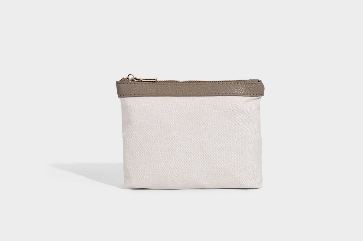 Structured trapezoid tote bag in taupe pebbled leather-look finish with gold-tone turn-lock hardware, dual top handles, and