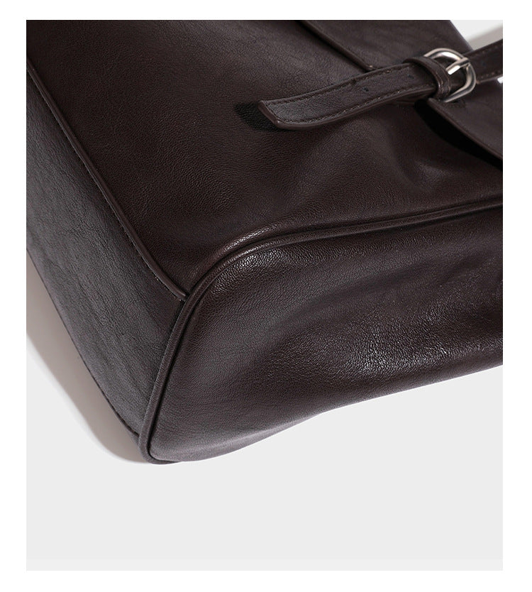Large structured vintage-style tote bag with flap-front turn-lock closure, twin buckle straps, and double shoulder handles