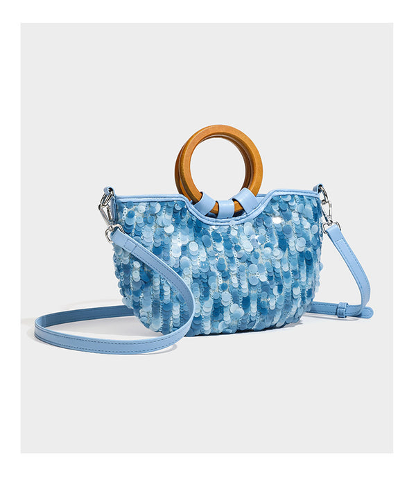 Small sequin half-moon handbag with circular wood-look ring handles and detachable leather-look shoulder strap, detail view