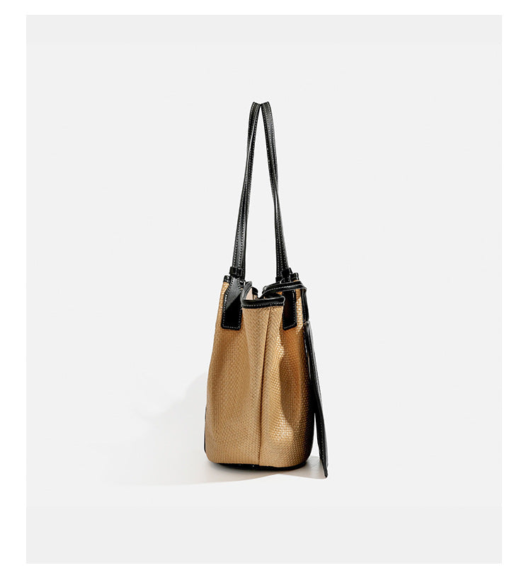 Tan woven tote bag with contrasting leather-look trim, long shoulder straps, and detachable rectangular zip pouch, detail