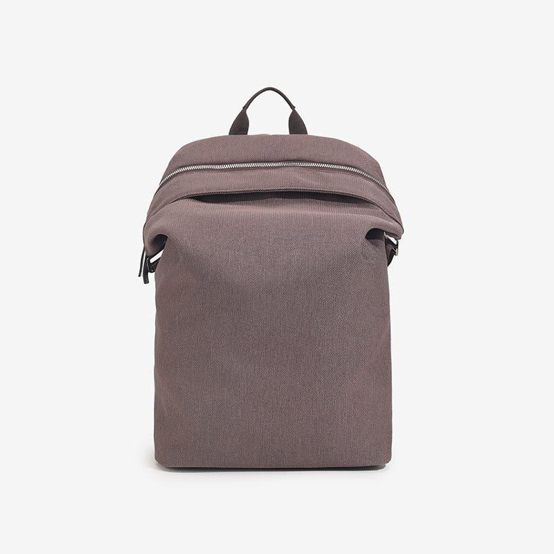 Structured matte nylon backpack with top zip closure, front zip pocket, top carry handle, and adjustable shoulder straps