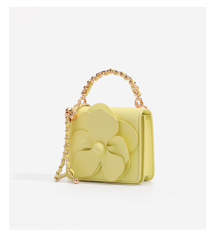 Small structured rectangular crossbody bag with layered 3D flower appliqué and gold-tone chain strap, detail view 9