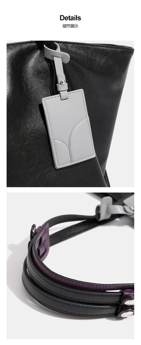 Large soft trapezoid tote bag with leather-look finish, dual shoulder straps, and gray hanging card tag, detail view 13
