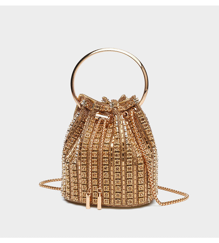 Mini crystal rhinestone bucket bag with circular ring top handle, drawstring closure, and silver chain shoulder strap, detail