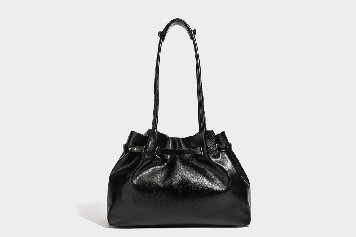 Glänzende schwarze, weich fallende Schultertasche mit gerafftem Abschluss, zwei langen Trageriemen, silberfarbenen Beschlägen und abnehmbarem Umhängeriemen
