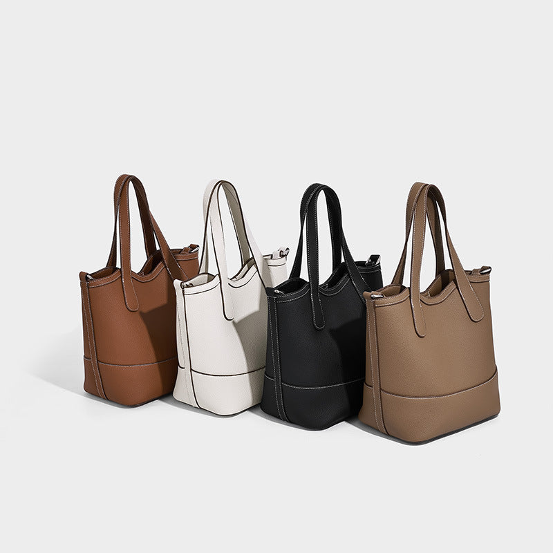 Structured pebbled-finish tote bag in caramel brown with dual top handles, detachable crossbody strap, and removable zip