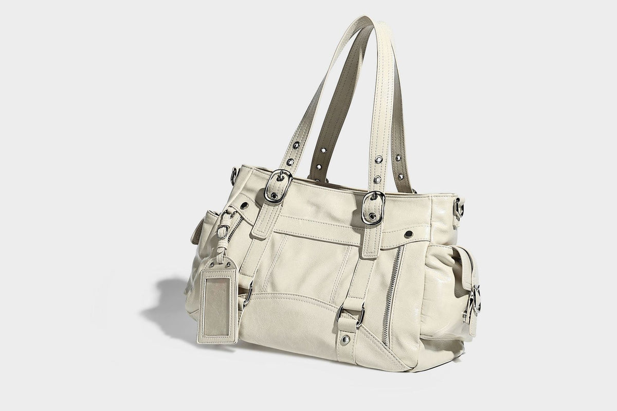Glossy structured black tote shoulder bag with silver buckle hardware, zip pockets, dual top handles, and detachable, detail