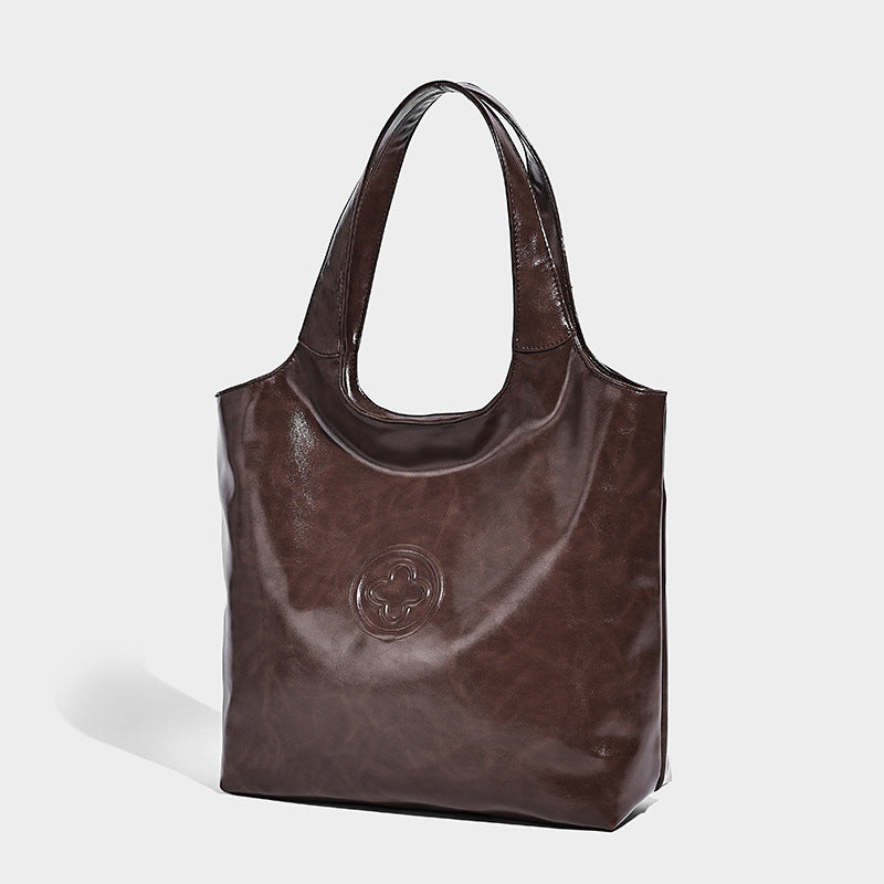 Glossy oil-wax leather-look open-top tote shoulder bag with embossed circular logo and long double straps, detail view 7
