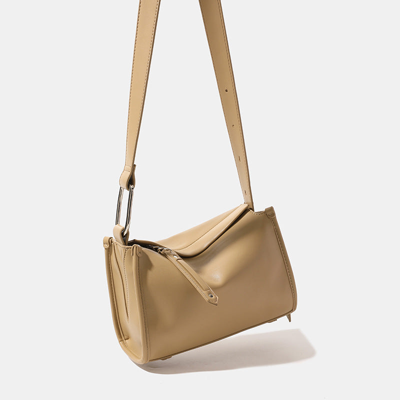 Structured smooth leather-look shoulder bag with top zip closure, tassel pull, and adjustable crossbody strap in khaki