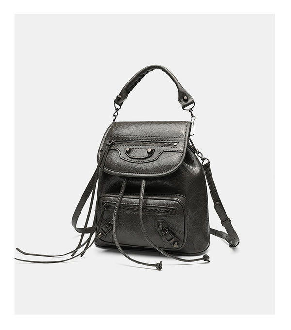 Small structured glossy leather-look convertible backpack handbag in black with flap closure, front zip pockets, metal stud