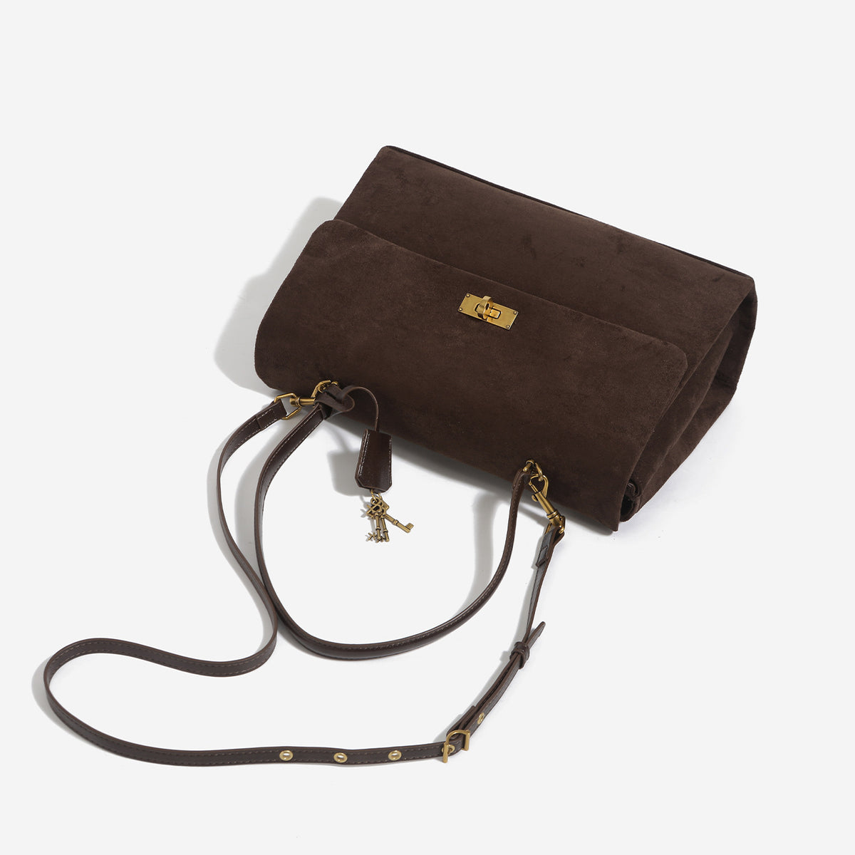 Large structured dark brown suede-finish satchel bag with gold-tone turn-lock closure, key charm accent, and detachable