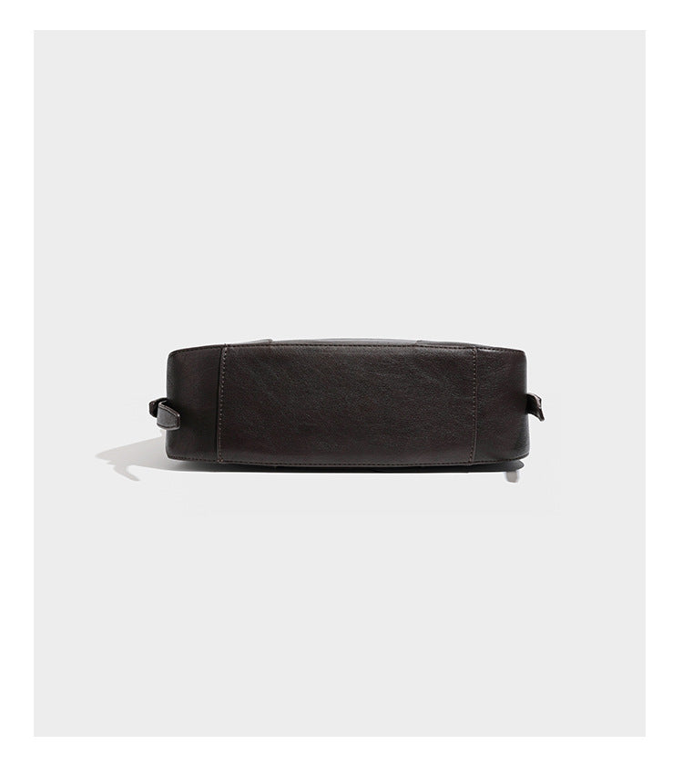 Slouchy crescent hobo shoulder bag in dark brown pebbled leather-look finish with zip top and long shoulder strap, detail