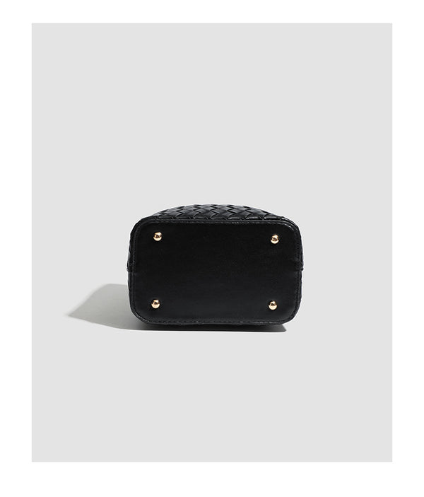 Black woven leather-look bucket bag with gold-tone clip closure, top handle, detachable shoulder strap, and knit bunny charm