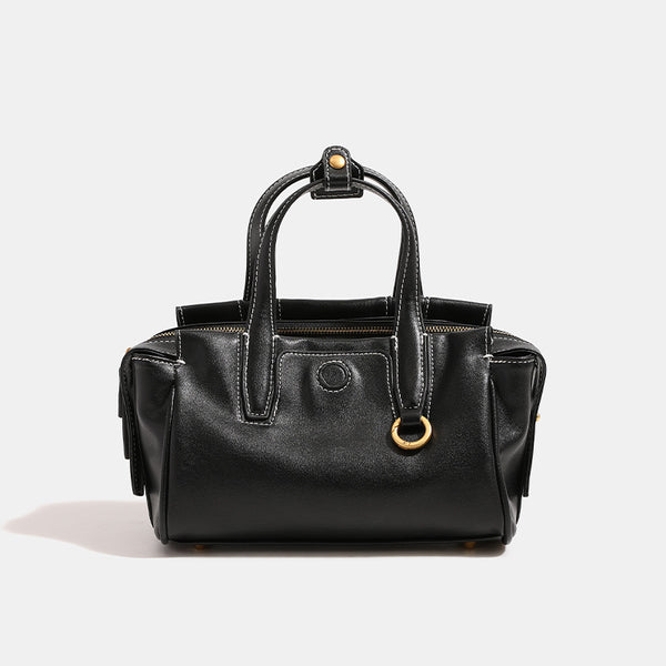 Compact structured satchel bag with dual top handles, gold-tone O-ring hardware, contrast topstitching, and detachable