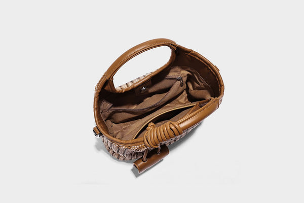 Small structured woven tote crossbody bag with ring top handle, leather-look brown trim, front patch pocket, and detachable