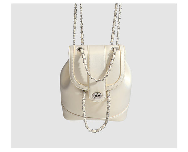 Small pearl-gloss backpack handbag with woven silver chain straps and turn-lock flap closure, detail view 14
