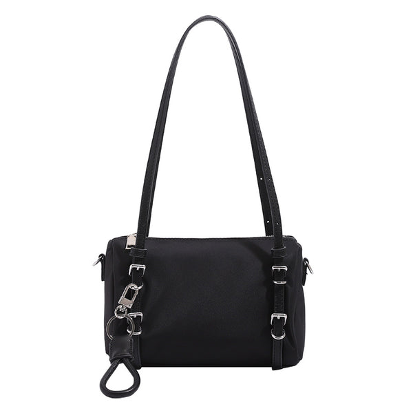 Compact nylon Boston barrel bag with zip-top closure, silver-tone hardware, dual slim handles, and detachable crossbody