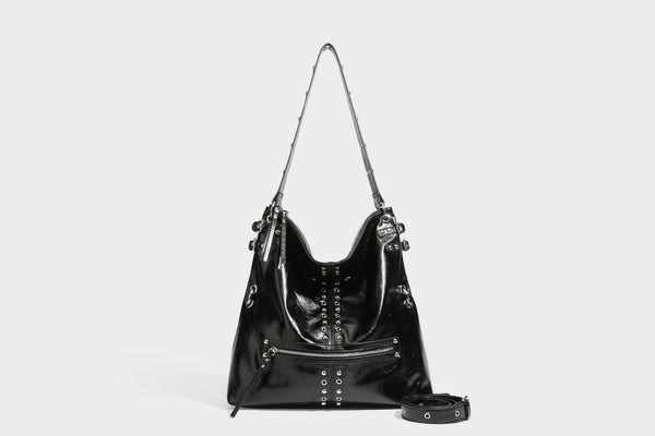Black glossy leather-look slouchy shoulder bag with silver stud and eyelet hardware, top zip closure, front zip pocket, and