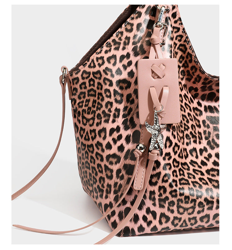 Large leopard print shoulder tote bag with glossy finish, long double straps, front zip pocket, silver-tone hardware, and