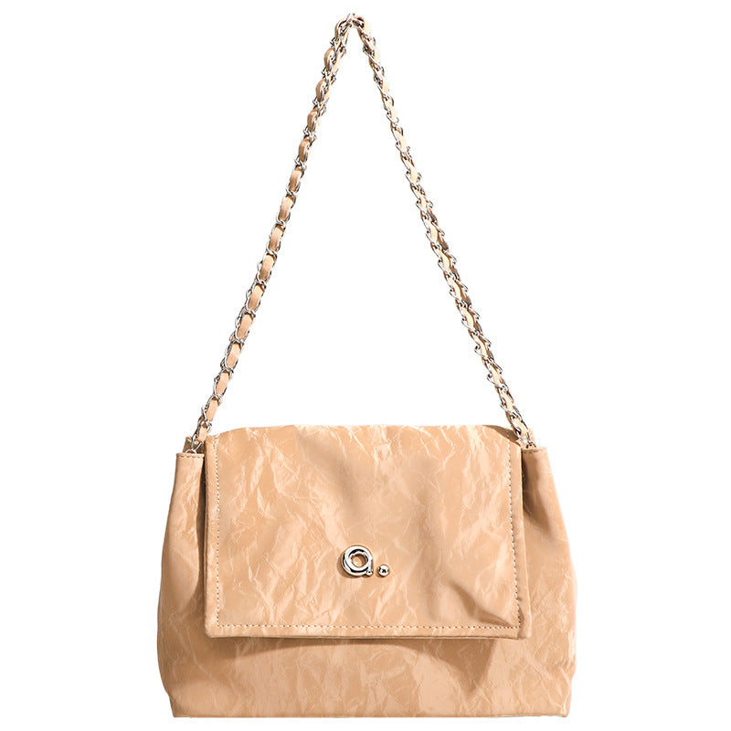 Crinkle-finish leather-look shoulder bag with woven tan-and-metal chain strap and front flap turn-lock closure, detail view 5