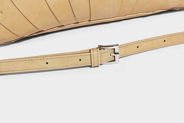 Structured dome satchel with fan-pleated leather-look exterior, dual top handles, and detachable shoulder strap, detail view