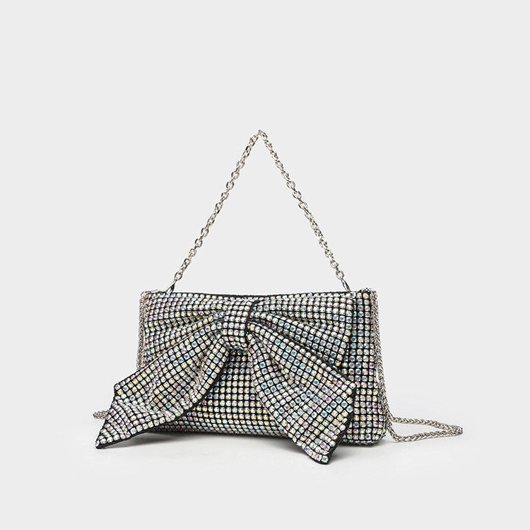 Small rectangular rhinestone-covered bow clutch crossbody bag with silver chain strap, front view