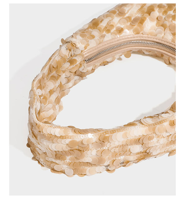 Slouchy crescent hobo shoulder bag covered in overlapping reflective sequin discs with a single integrated strap and top-zip