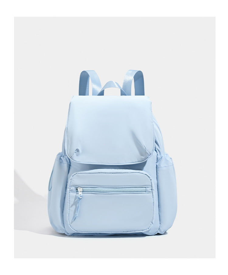 Soft matte nylon flap backpack with front zip pocket and side drawcord pockets, detail view 15
