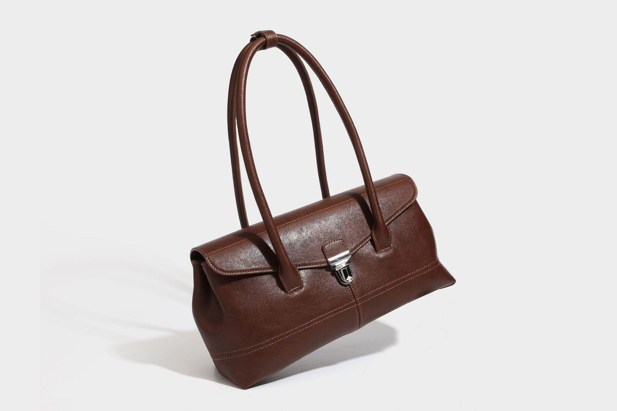 Structured rectangular satchel bag with dual rounded top handles and central metal turn-lock flap closure, detail view 21