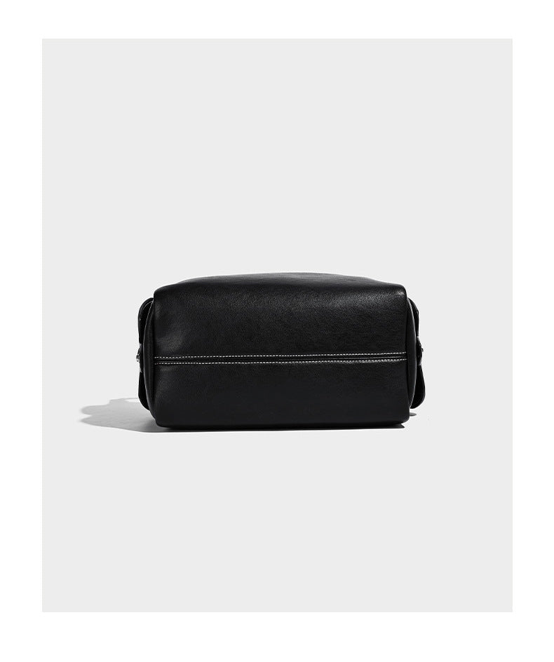 Small slouchy moto-style crossbody bag in smooth matte leather-look finish with white contrast stitching, silver-tone, detail
