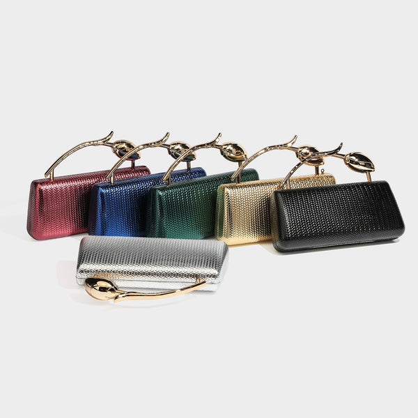 Structured rectangular metallic woven clutch bag with sculptural gold-tone leaf top handle and detachable chain strap, detail