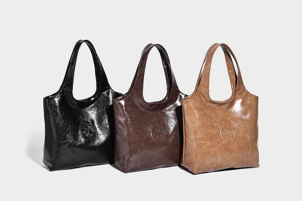 Glossy oil-wax leather-look open-top tote shoulder bag with embossed circular logo and long double straps, detail view 14