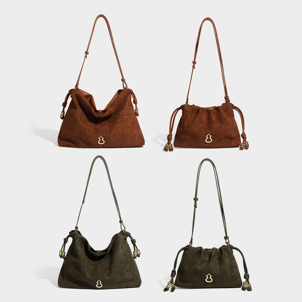 Suede-look drawstring shoulder bag in brown with smooth trim, knotted bead drawstring closure, slim adjustable strap, and