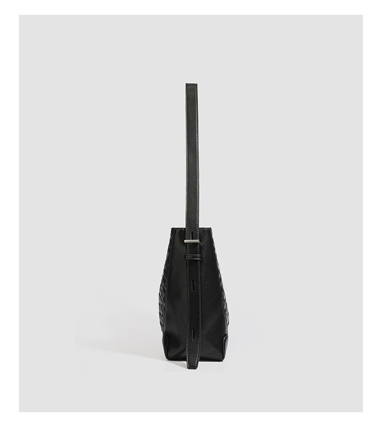 Large black bucket shoulder bag with diamond woven leather-look front panel, smooth side panels, magnetic snap closure, and