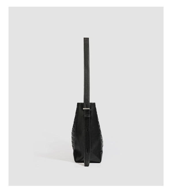 Large black bucket shoulder bag with diamond woven leather-look front panel, smooth side panels, magnetic snap closure, and