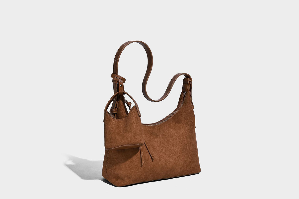 Dark brown suede-look hobo shoulder bag with top zip closure, adjustable strap, and small detachable mini pouch, detail view