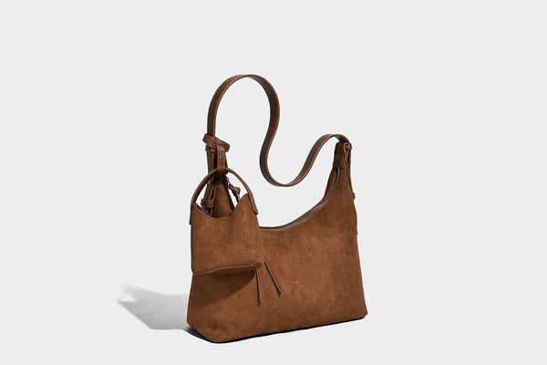 Dark brown suede-look hobo shoulder bag with top zip closure, adjustable strap, and small detachable mini pouch, detail view