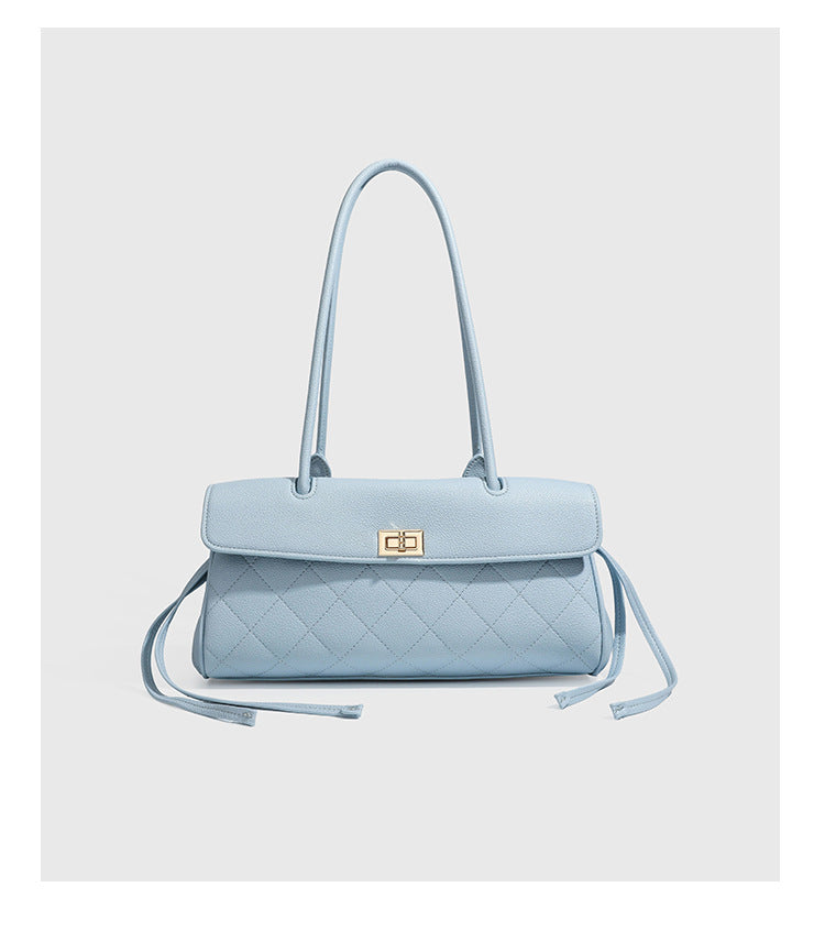 Structured black diamond-quilted shoulder bag with gold-tone turn-lock flap closure and dual round shoulder straps, detail