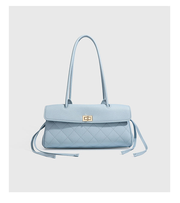 Structured black diamond-quilted shoulder bag with gold-tone turn-lock flap closure and dual round shoulder straps, detail