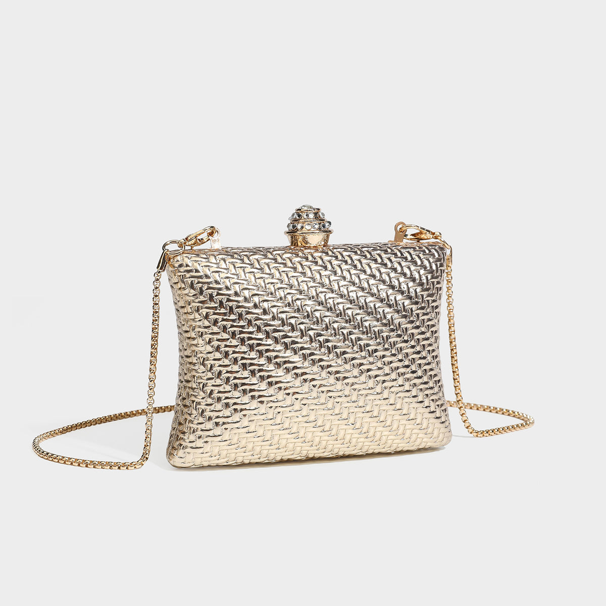 Small structured rectangular metallic woven-texture clutch bag with jeweled knob clasp and gold-tone chain strap, detail view
