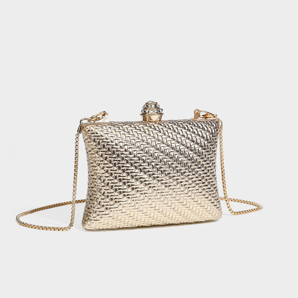 Small structured rectangular metallic woven-texture clutch bag with jeweled knob clasp and gold-tone chain strap, detail view