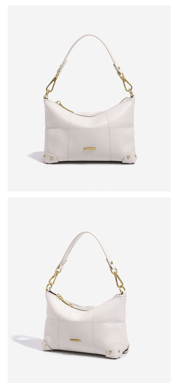 Small soft-structured shoulder bag with curved zip closure, stitched panel detailing, and gold-tone hardware, detail view 11