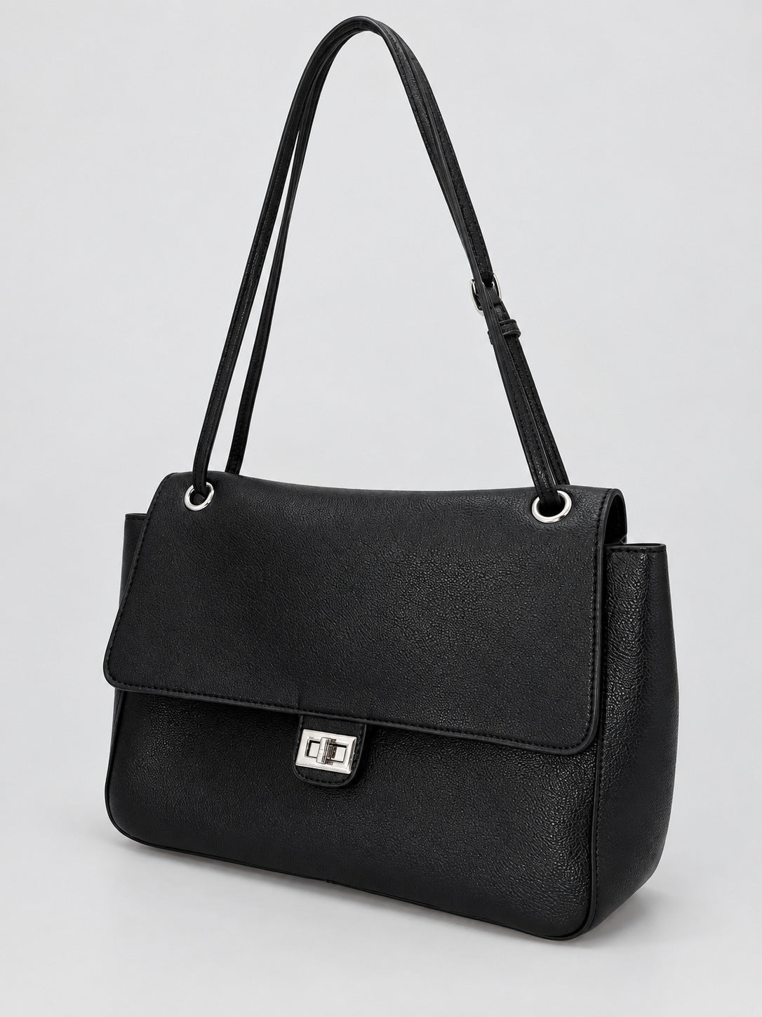 Structured black flap shoulder bag with pebbled texture, silver-tone turn-lock closure, and adjustable single shoulder strap