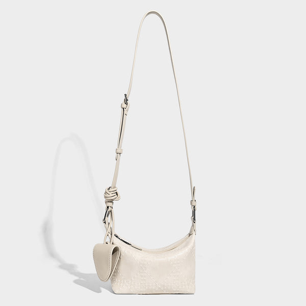 Small embossed half-moon shoulder bag with top zipper, detachable front pouch, and adjustable slim strap, detail view 4