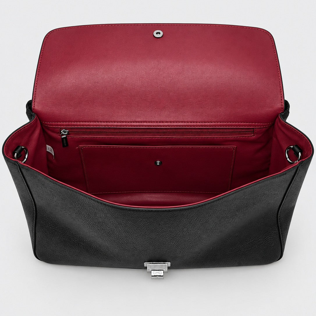 Structured black flap shoulder bag with pebbled texture, silver-tone turn-lock closure, and adjustable single shoulder strap
