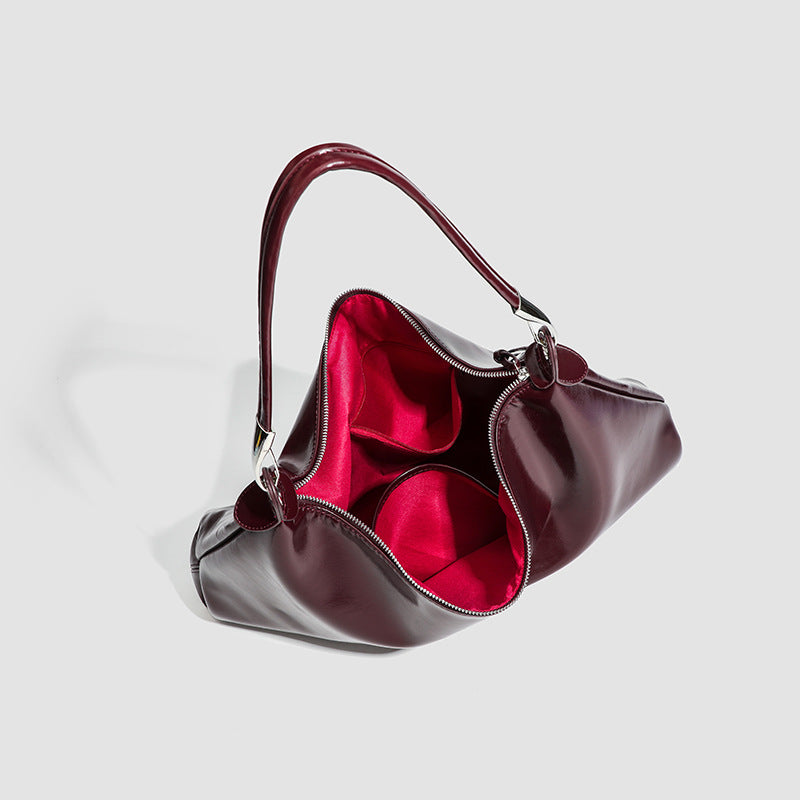Glossy structured shoulder tote bag with silver-tone hardware and top zip closure, detail view 3