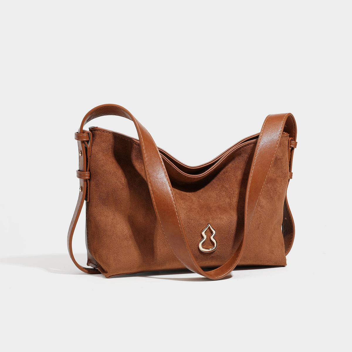 Slouchy suede-finish brown shoulder bag with long single strap and small gold-tone logo emblem on front, detail view 46