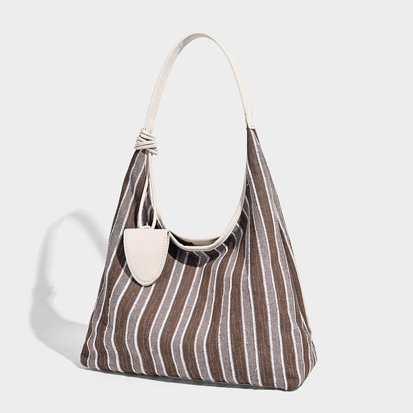 Slouchy striped canvas hobo shoulder bag with cream trim and long knotted strap, front view