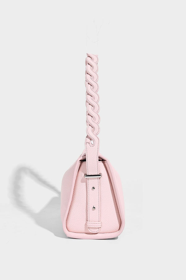 Small structured pebbled-finish shoulder bag with braided top handle, detachable crossbody strap, floral tassel charm, and